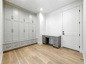 Unfurnished office with light wood-style floors, recessed lighting, and built in study area