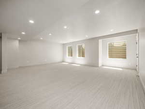 Spare room featuring recessed lighting and light carpet