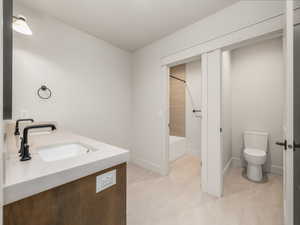 Bathroom featuring double vanity and shower / bath combination