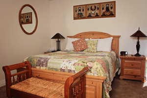 Bedroom with dark colored carpet and crown molding