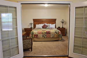 Bedroom with a closet, crown molding, and wood finished floors