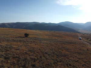 View of mountain background featuring rural landscape