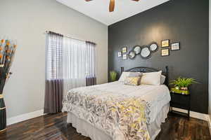 Bedroom featuring dark wood-type flooring and a ceiling fan