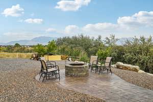 View of patio featuring an outdoor fire pit and a mountain view