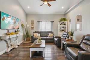 Living room with ceiling fan, dark wood-style flooring, and recessed lighting