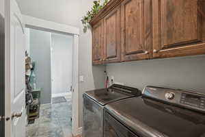 Laundry room with cabinet space and washing machine and clothes dryer