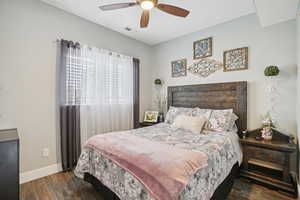 Bedroom with dark wood-style flooring and a ceiling fan