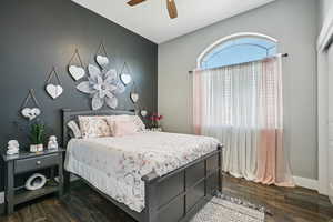 Bedroom featuring dark wood finished floors and ceiling fan