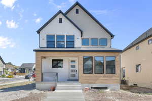 View of front facade with covered porch and brick siding