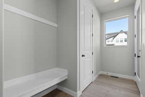 Mudroom with light wood-style flooring and recessed lighting
