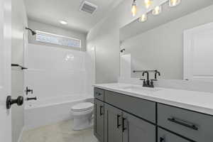 Full bath with shower / bathtub combination, vanity, and light marble finish floors
