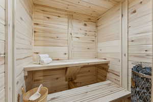 Relaxing sauna with wood ceiling and wooden walls