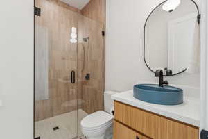 Full bathroom featuring vanity and a stall shower