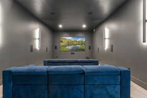 Carpeted home theater with baseboards and recessed lighting