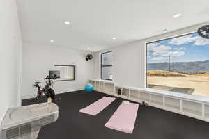 Exercise area featuring a mountain view, recessed lighting, and radiator heating unit