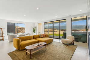 Living area with a mountain view and recessed lighting