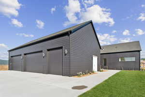 Garage featuring concrete driveway
