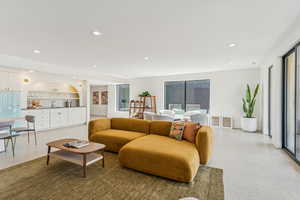 Living area with recessed lighting, healthy amount of natural light, and speckled floor