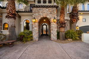 View of exterior entry featuring stone siding and stucco siding