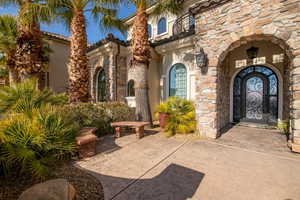 View of exterior entry with stone siding and stucco siding