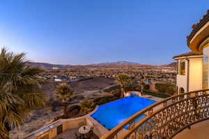 Outdoor pool with a mountain view and a balcony
