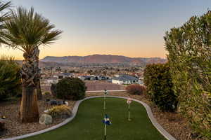 View of home's community with a putting green, a mountain view, and a residential view