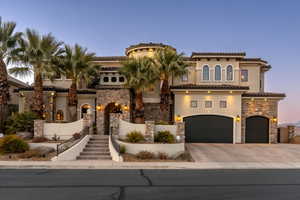 Mediterranean / spanish-style home featuring stone siding, stucco siding, concrete driveway, an attached garage, and a tile roof