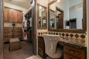 Bathroom featuring a spacious closet and vanity