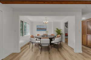 Dining area featuring light wood-style floors and a chandelier