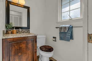 Bathroom featuring vanity and decorative backsplash