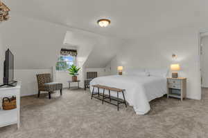 Bedroom with light carpet and lofted ceiling