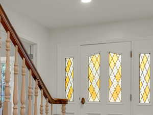Entrance foyer featuring stairs, wood finished floors, and plenty of natural light