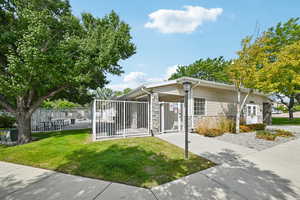 View of front of property with stone siding and a gate