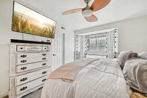 Bedroom featuring ceiling fan and carpet