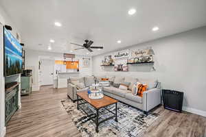 Living area featuring recessed lighting, light wood-style flooring, and a ceiling fan