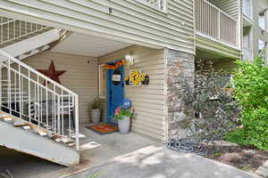 Doorway to property with stone siding
