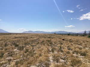 View of mountain backdrop featuring rural landscape