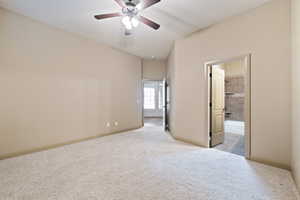 Carpeted guest room with a ceiling fan and baseboards