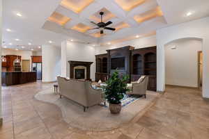 Living area featuring recessed lighting, coffered ceiling, ceiling fan, and a high end fireplace