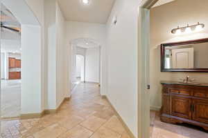 Hall featuring arched walkways and recessed lighting