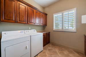 Laundry area featuring cabinet space, washing machine and dryer