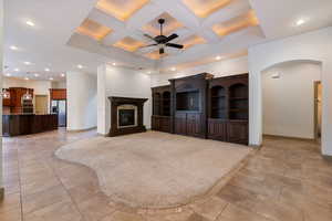 Living area featuring recessed lighting, coffered ceiling, ceiling fan, and a high end fireplace