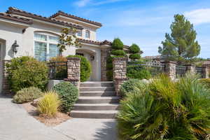 Entrance to property featuring stucco siding and stone siding