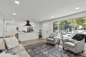 Living area featuring light wood-style floors and recessed lighting