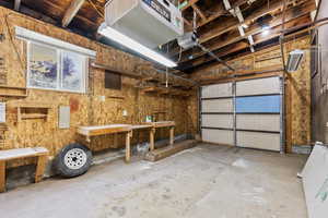 Garage featuring a heating unit and a garage door opener