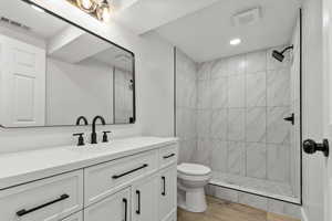 Bathroom featuring vanity, a stall shower, light wood-style floors, and recessed lighting