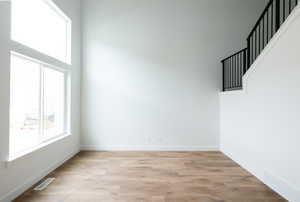 Empty room with light wood-type flooring and baseboards