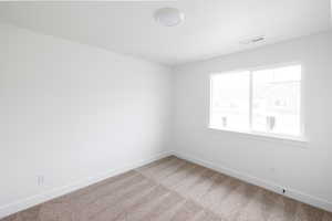 Unfurnished room with baseboards and carpet flooring