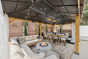 View of patio featuring an outdoor living space with a fire pit