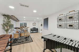 Recreation room with recessed lighting and light wood-style flooring
